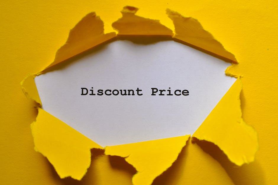 A piece of bright yellow paper with torn edges is peeled back to reveal a white rectangular section underneath. On this white section, the words 'Discount Price' are printed in bold black typewriter-style font. The torn paper creates a jagged, irregular opening that emphasizes the contrast between the vivid yellow exterior and the plain white interior. The background is also yellow, matching the outer paper, and the scene is lit evenly, highlighting the texture of the torn edges and the clean appearance of the typed message. This image visually suggests a promotional or sale indication that could relate to affordable or alternative waste disposal options, such as independent rubbish collection services, complementing content on rubbish removal or private waste handling. The overall composition is straightforward, focusing on the announcement of a reduced or special price, with a neutral and professional tone suitable for accessibility and SEO optimization related to waste management topics.